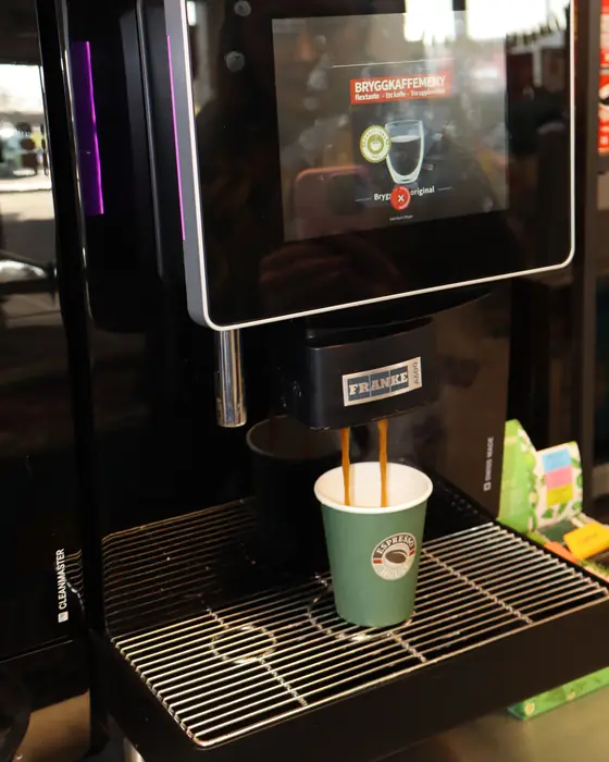 Coffee pouring into a cup at a 24SJU coffee station